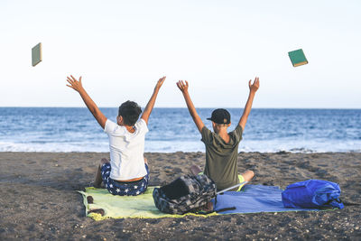 Friends sitting on beach