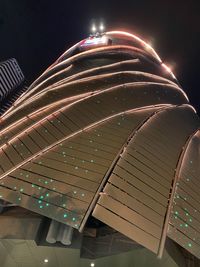 Low angle view of illuminated building against sky at night