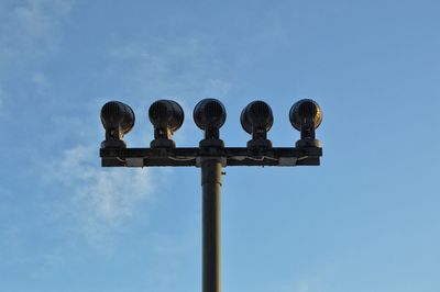 Low angle view of floodlight against sky