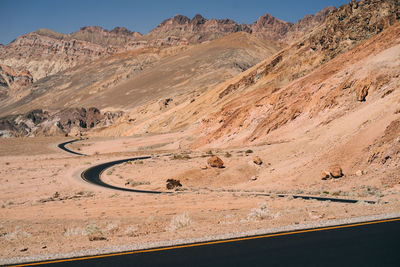 Scenic view of desert road against sky