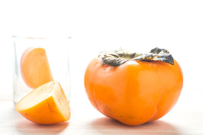 Close-up of persimmons over white background