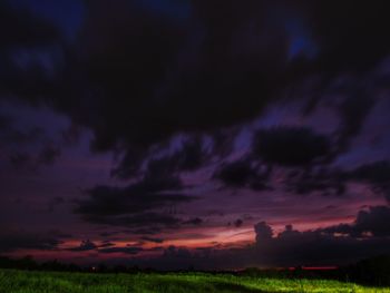 Scenic view of dramatic sky over field