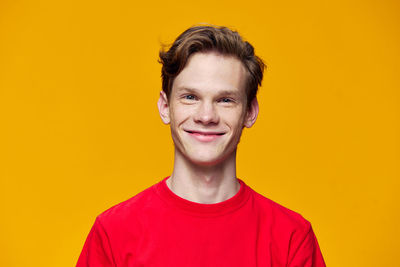 Portrait of young man against yellow background