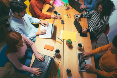 High angle view of people sitting on table