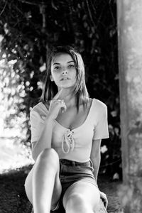 Portrait of teenage girl sitting outdoors