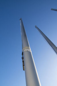 Flagpoles on a cold sunny winter day against a blue clear sky