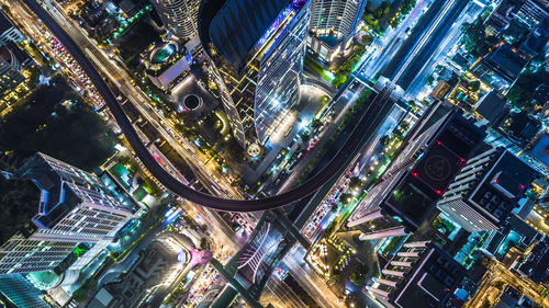 High angle view of illuminated street amidst buildings in city