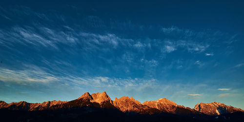 Scenic view of mountains against blue sky