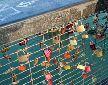 Padlocks attached on bridge railing over river