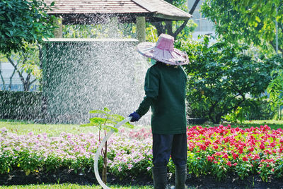 Man watering flowers in garden