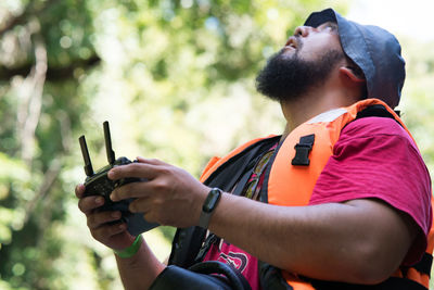 Midsection of man holding mobile phone