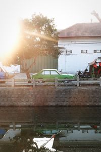 Boats moored in city against sky
