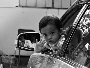 Portrait of cute boy in car