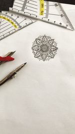 High angle view of pencil on table against white background