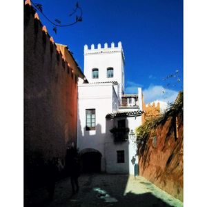 View of buildings against blue sky