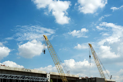 Low angle view of crane against sky