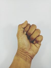 Close-up of hand against white background