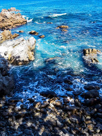 High angle view of rocks in sea