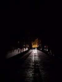 Man walking on illuminated street at night