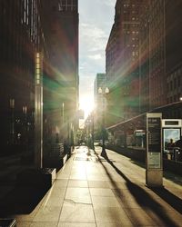 Street amidst buildings against sky in city