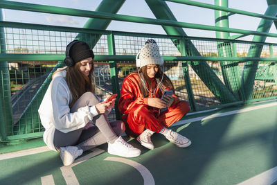 Portrait of young woman sitting outdoors