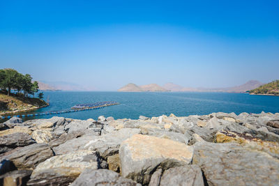 Scenic view of sea against clear blue sky