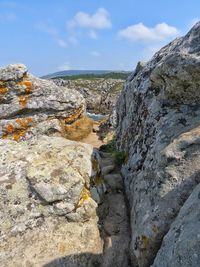 Scenic view of cliff against sky