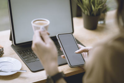 Midsection of man using laptop on table
