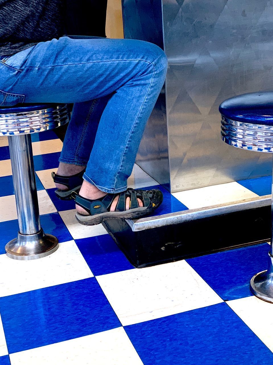 LOW SECTION OF MAN SITTING ON FLOOR