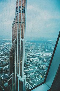 High angle view of city by sea against sky