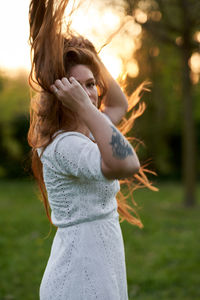 Side view of girl standing on field