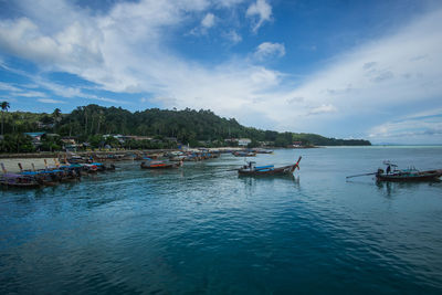 Boats in sea against sky