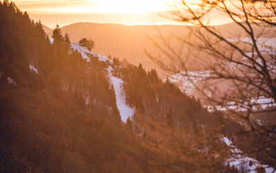 Scenic view of snowcapped mountains against sky during sunset