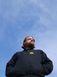 Low angle view of woman standing against sky