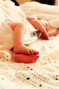 Newborn baby sleeping on bed at home