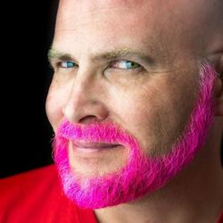 Headshot of man with pink beard