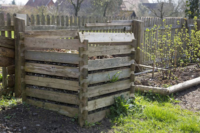 Row of wooden fence on field