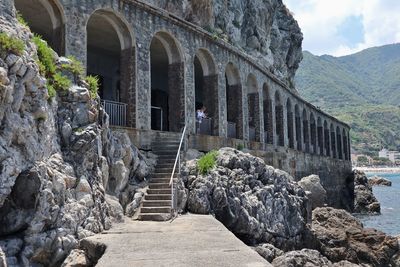 Walkway amidst rocks against mountain