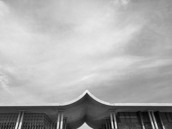 Low angle view of building against cloudy sky