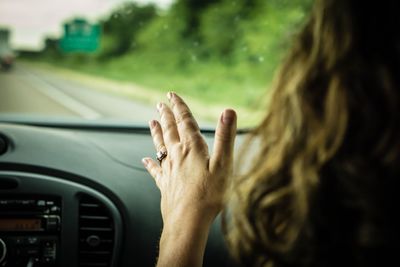 Cropped image of woman traveling in car