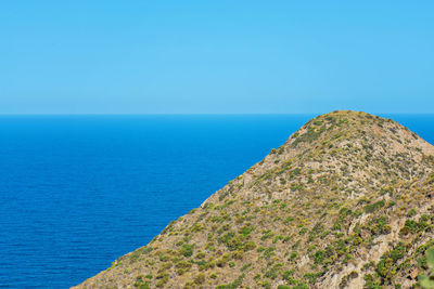 Scenic view of sea against clear blue sky