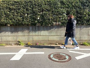 Full length of woman walking on road