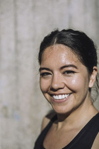 Portrait of smiling woman on sunny day