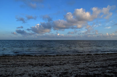 Scenic view of sea against blue sky