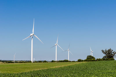 Row of three modern windmills in the countryside near tarariras, colonia. 