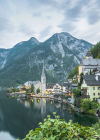 River amidst buildings in town against sky