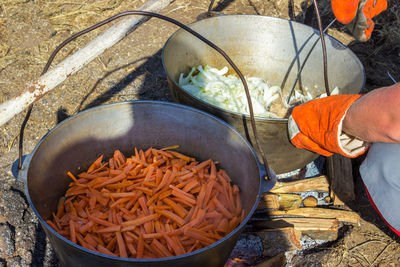 Cooking plov in the cauldron. only the meat in the cauldron. field kitchen. eastern cuisine.