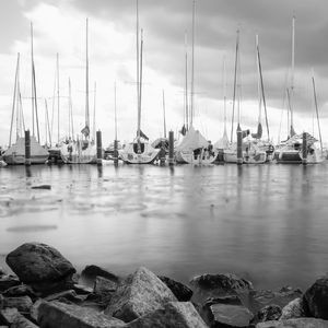 Sailboats in sea against sky