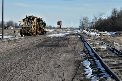 Railroad track on field against sky