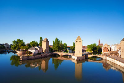 Arch bridge over river against buildings